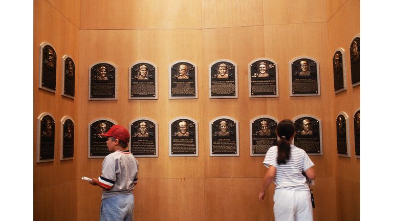 Two People Looking at Baseball Plaques