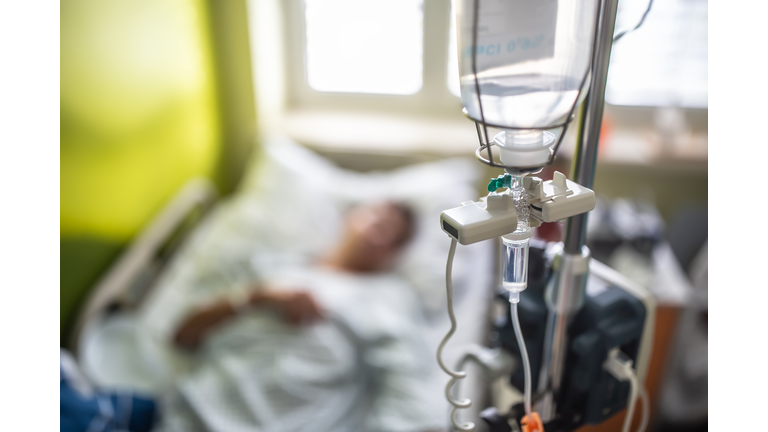 Drip infusion of a patient in a hospital room.