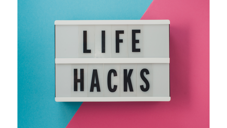 life hacks - text on a display on blue and pink bright background.