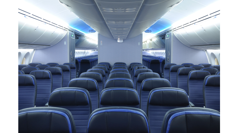 787 dreamliner commercial airplane cabin interior with blue leather seats