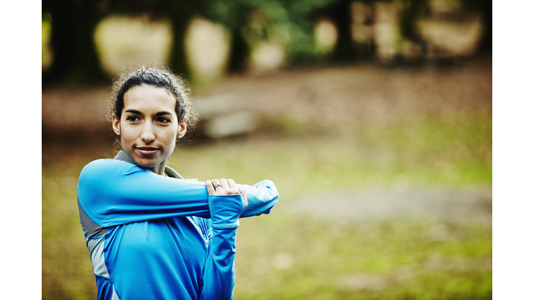 Female runner stretching before morning run