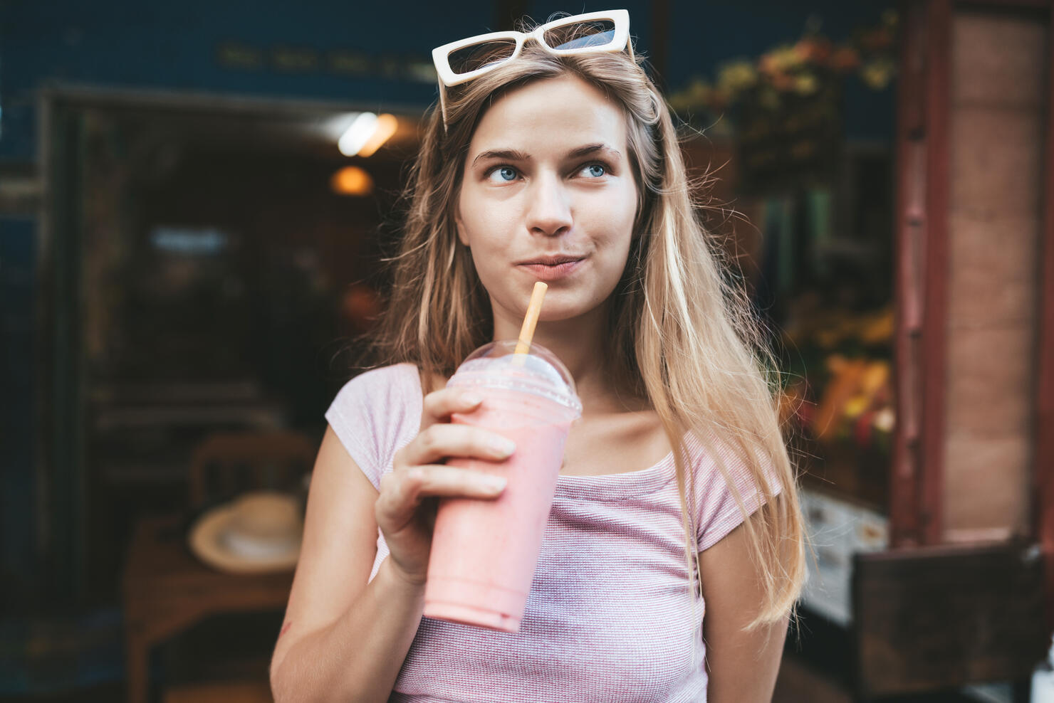Young blonde woman drinking strawberry smoothie,Chiang Mai,Thailand