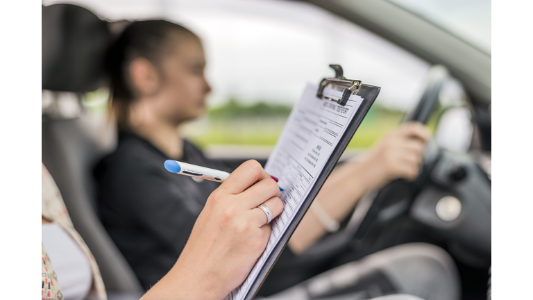 Teen  getting a driving lesson in the car