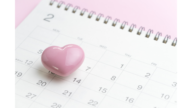 Calendar with pink heart shape on 14 February on pink background using as romantic Valentines day concept