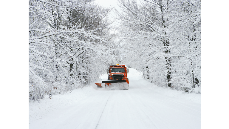 USA, Wisconsin, Door County, snow plow driving down road