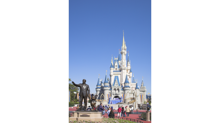 Walt Disney and Mickey Mouse Partners statue and Cinderella Castle, Magic Kingdom, Orlando, Florida, USA