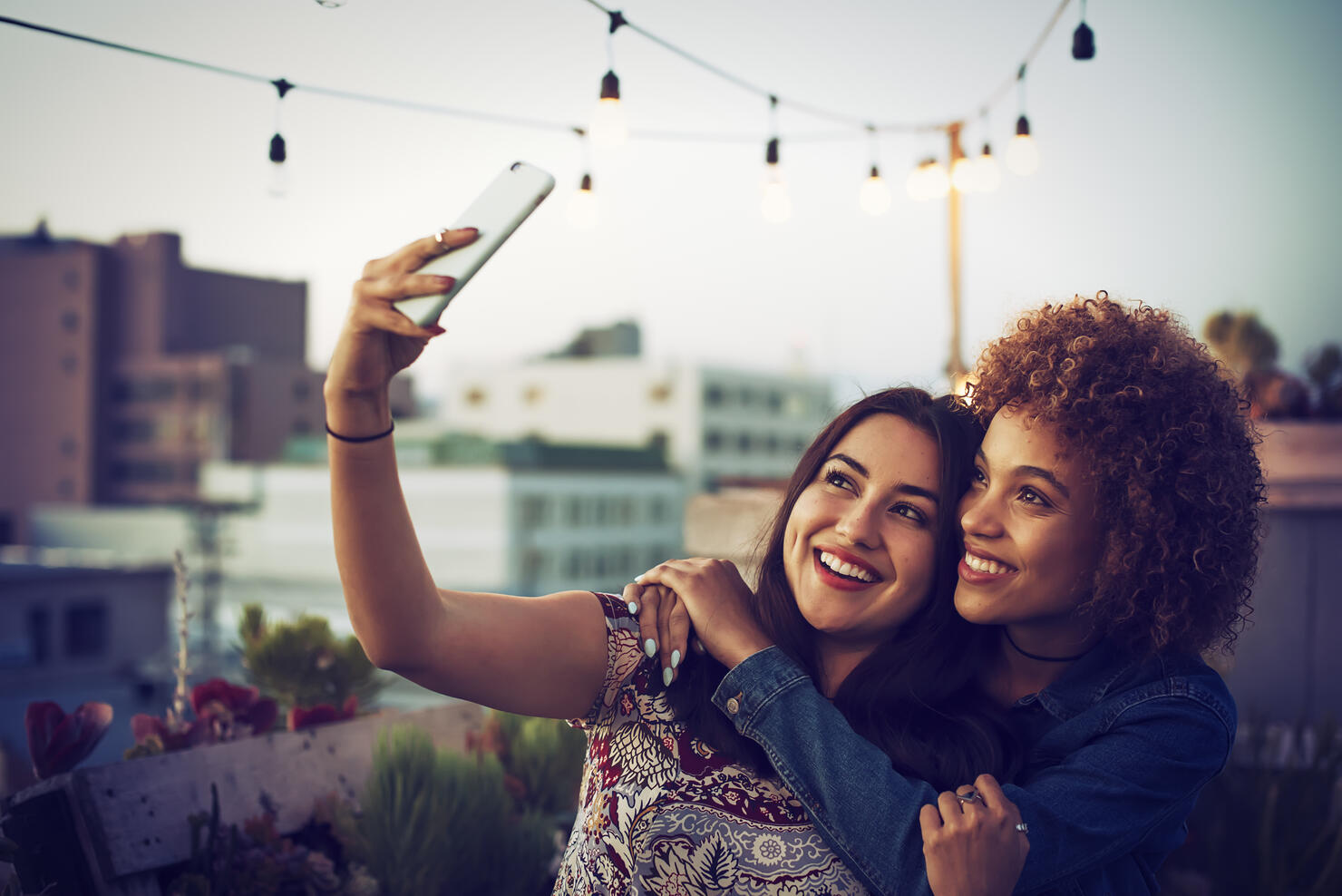 Friends taking a selfie on urban rooftop