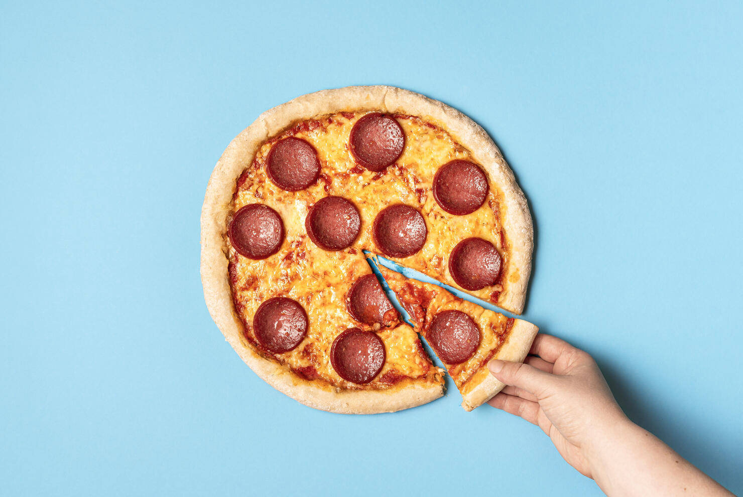 Pizza pepperoni and taking a slice of pizza. Eating pizza salami