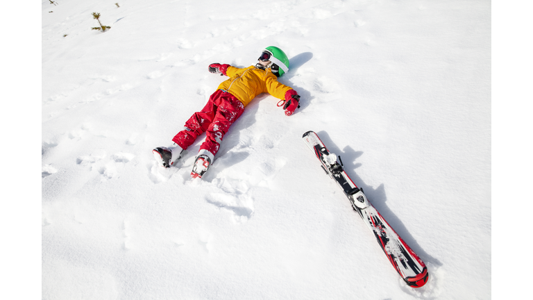 Child on snow with snowboard