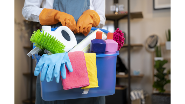 Woman holding cleaning products