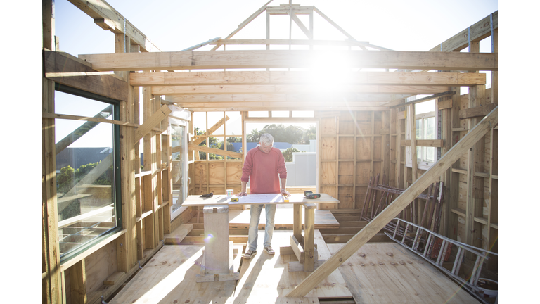 Builder working on a wood framed house