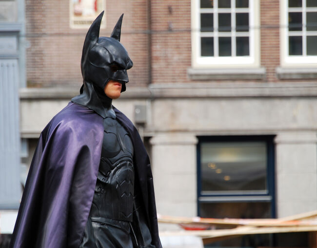 Actor in Batman costume in pose in central Dam square