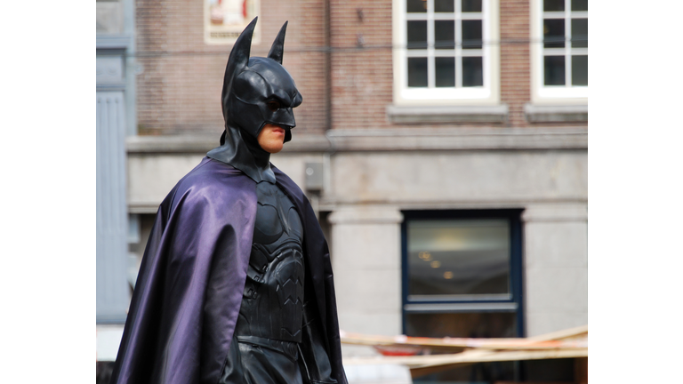 Actor in Batman costume in pose in central Dam square