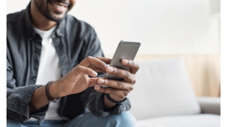 Young man using smart phone at home