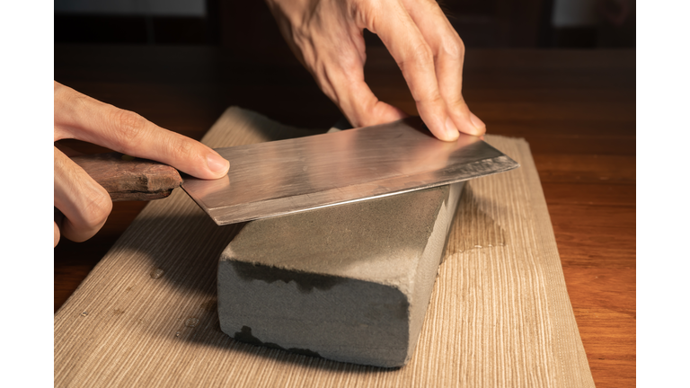 Sharpen a cleaver knife with a stone