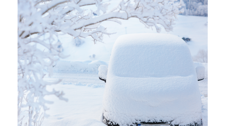 Car covered with snow after winter storm.