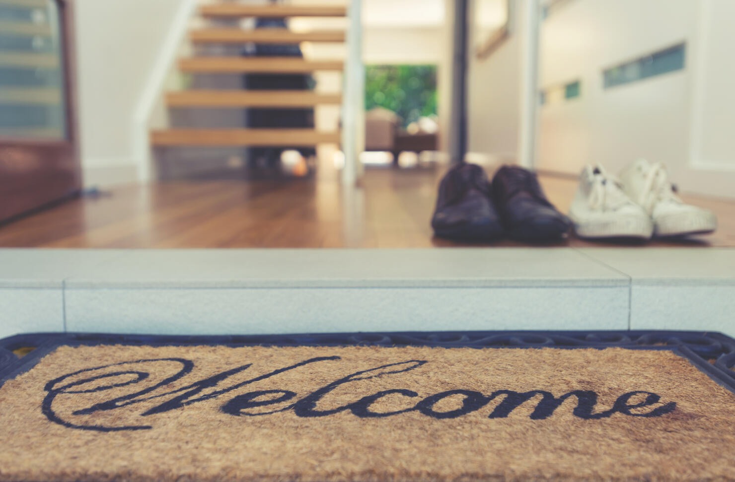 Welcome mat at the open front door.