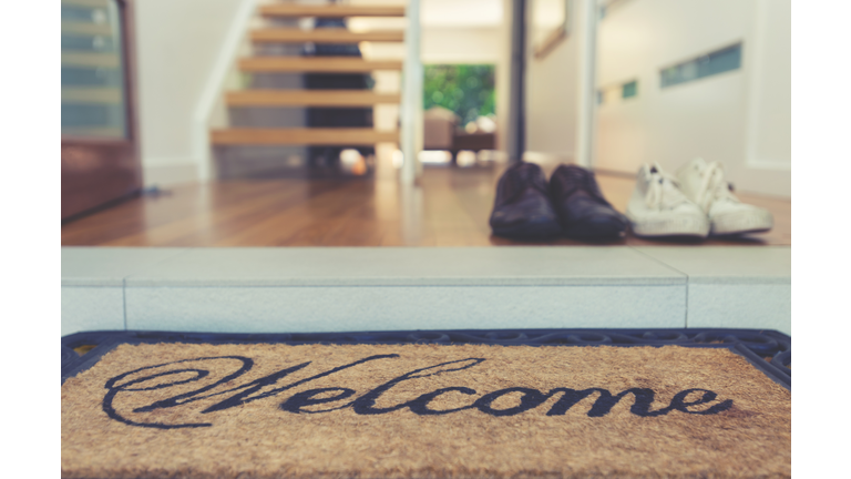 Welcome mat at the open front door.