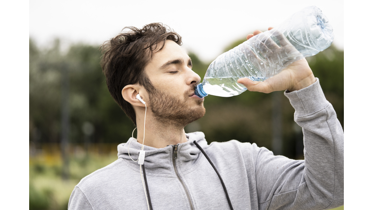 Young man drinking water