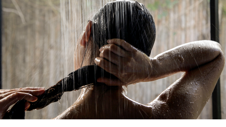Headshot, hispanic woman taking a shower