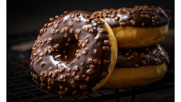 Chocolate-coated doughnuts, close-up, blurred, macro, sprinkle, delicious, assorted doughnuts, on a cooling rack, dark
