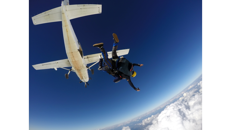 Sky dive tandem above the clouds