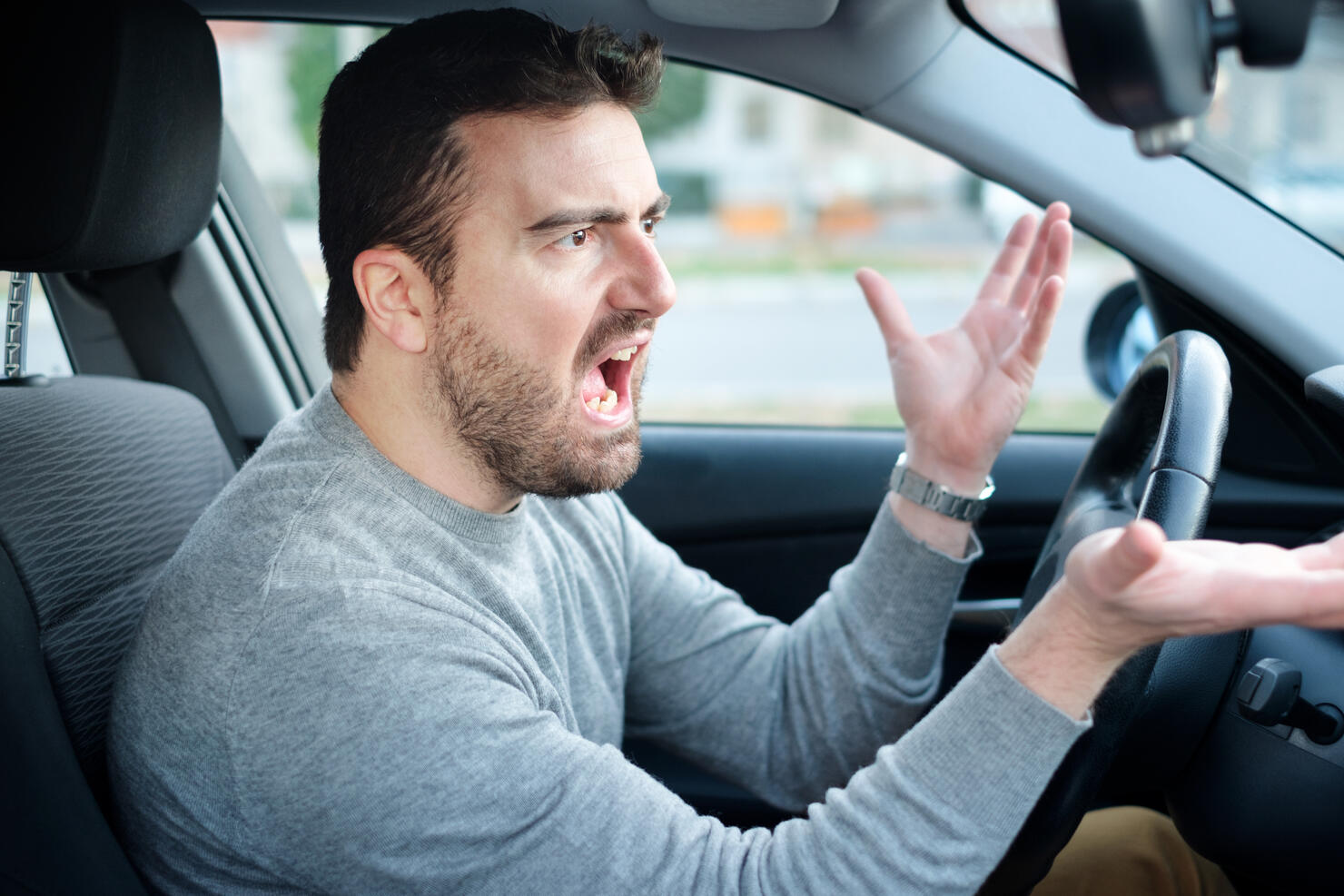 Face expression of angry driver arguing and gesturing