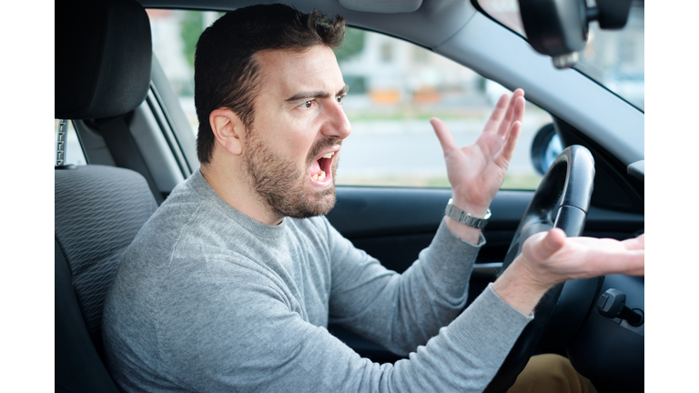 Face expression of angry driver arguing and gesturing
