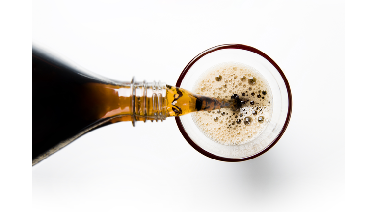 A glass of cola being poured into a glass