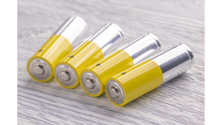 AA batteries on a white wooden table