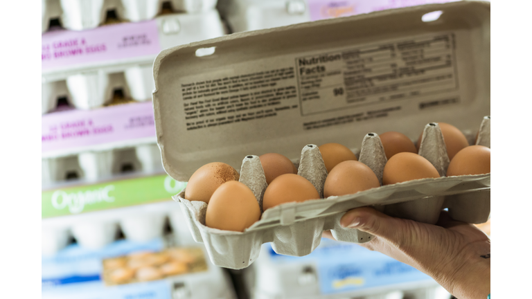 Woman grocery shopping in store supermarket aisle