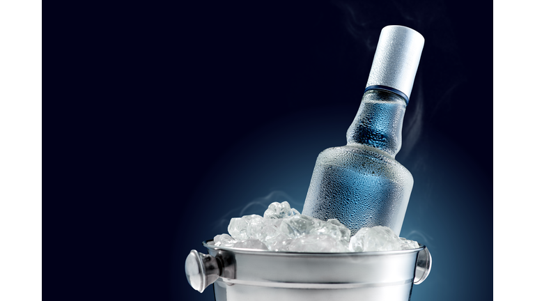 Bottle of cold vodka in bucket of ice