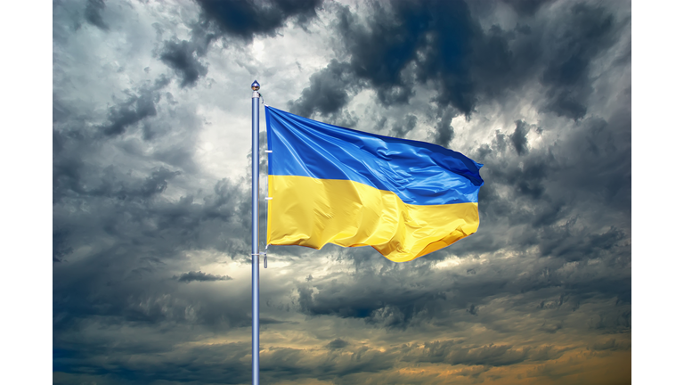 Ukraine flag. Ukrainian flag on black storm cloud sky. stormy weather