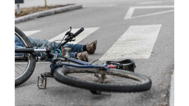 Traffic accident.Young man on bike hit by a car