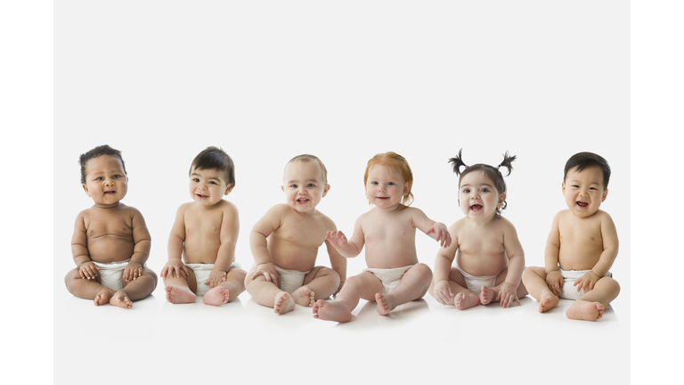 Studio shot of babies sitting in row