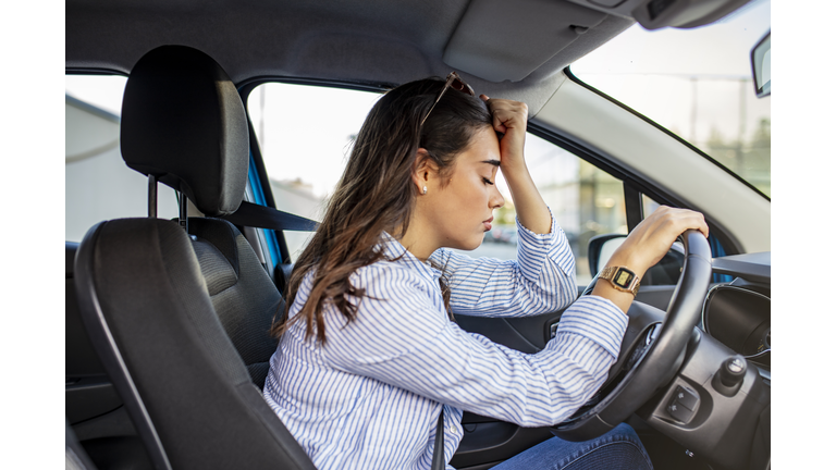 Stressed woman drive car feeling sad and angry.