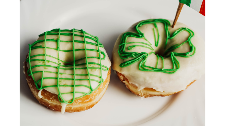 Image of two homemade donuts decorated with the flag of ireland for saint patrick's day