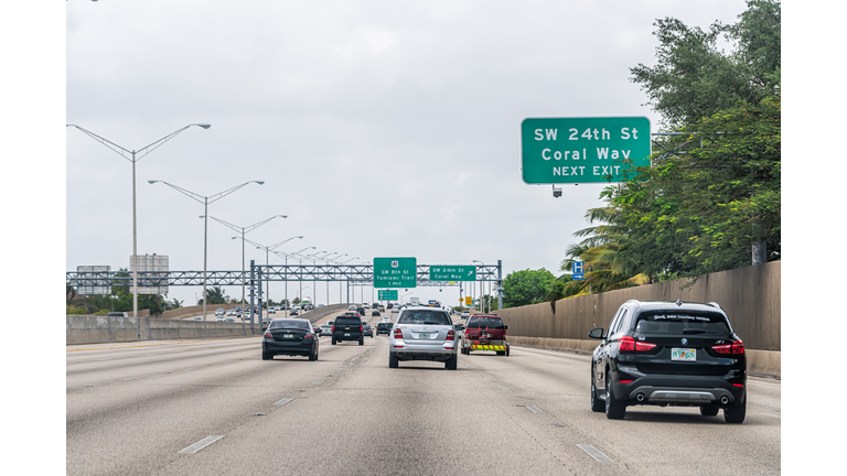 Miami highway green signs for Palmetto Expressway in Florida with SW 24th street Coral Way and Tamiami trail exit direction signs