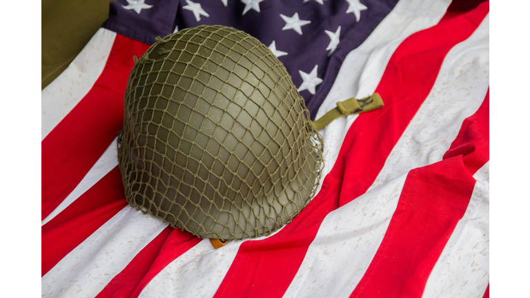 Soldier's helmet and the times of the Second World War and the US flag. Patriotism