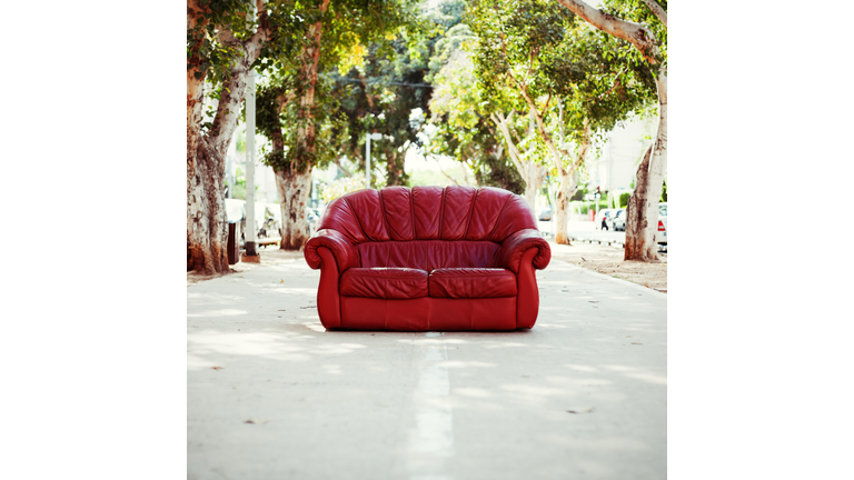 red vintage leather sofa on the street