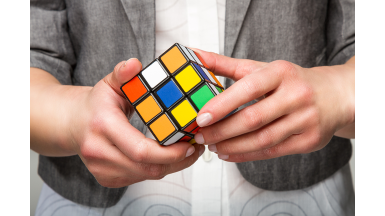 Hands holding color cube