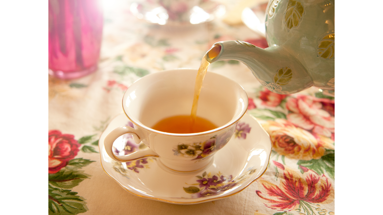 Tea party - Pouring tea into a tea cup