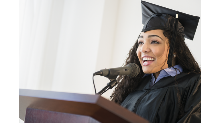 Hispanic student giving speech at graduation