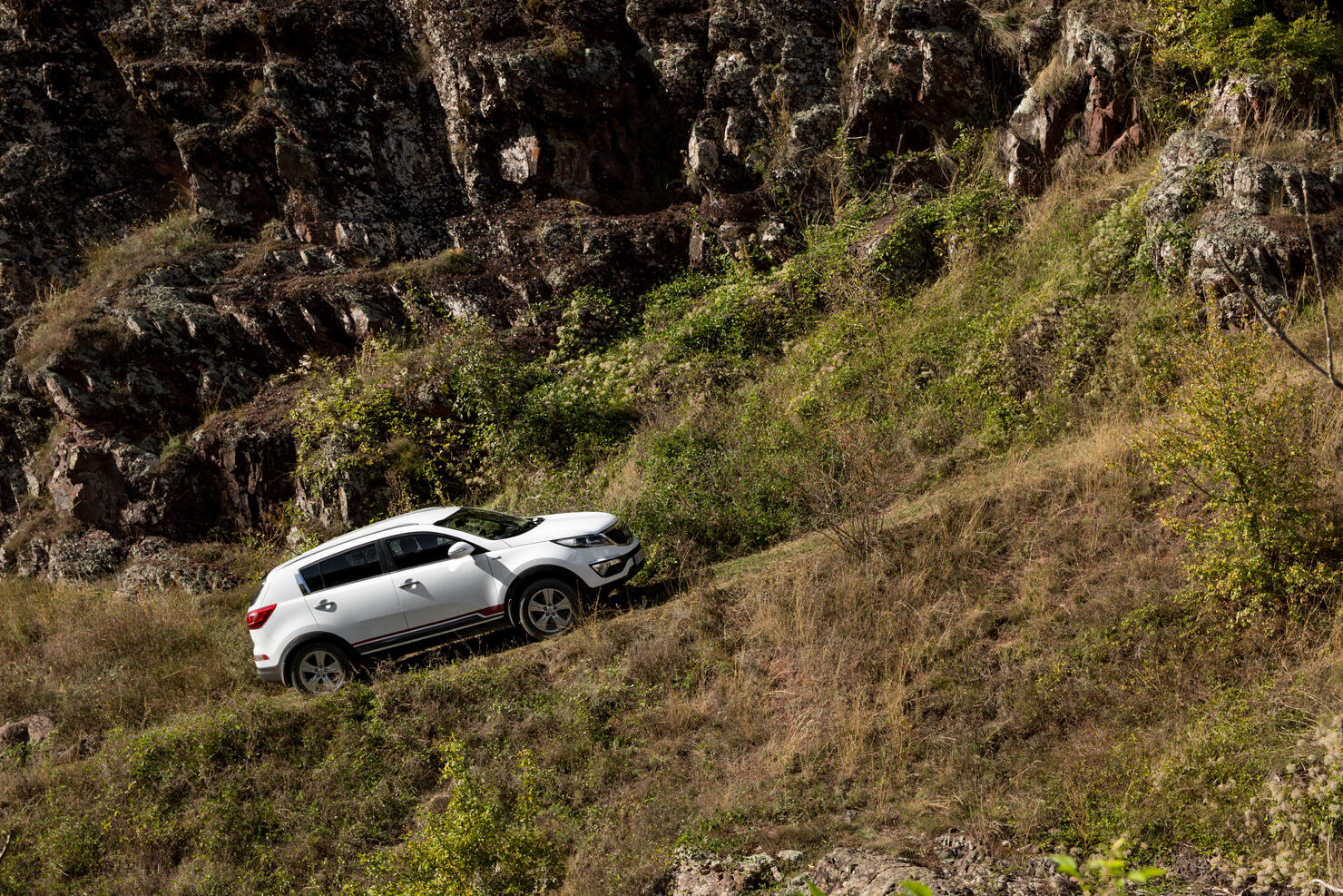 Zavoj, Serbia - 09.21.2018 / car Kia Sportage 2.0 CRDI awd or 4x4, goes uphill, on a macadam road.