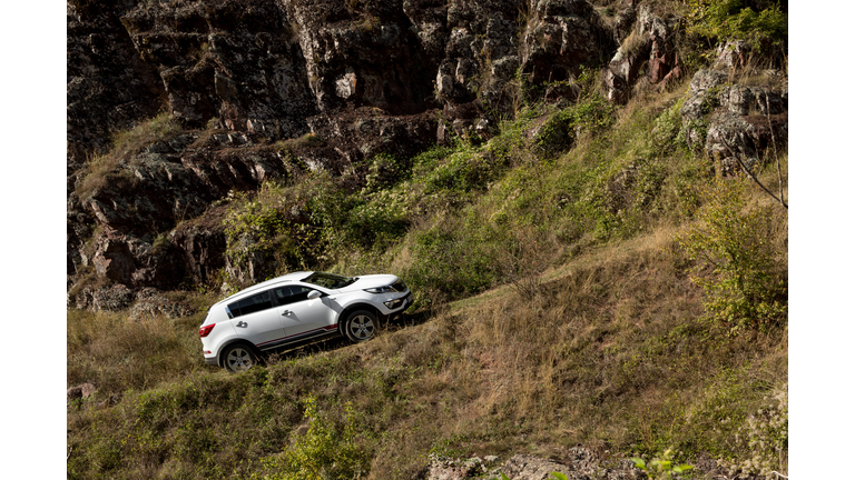 Zavoj, Serbia - 09.21.2018 / car Kia Sportage 2.0 CRDI awd or 4x4, goes uphill, on a macadam road.