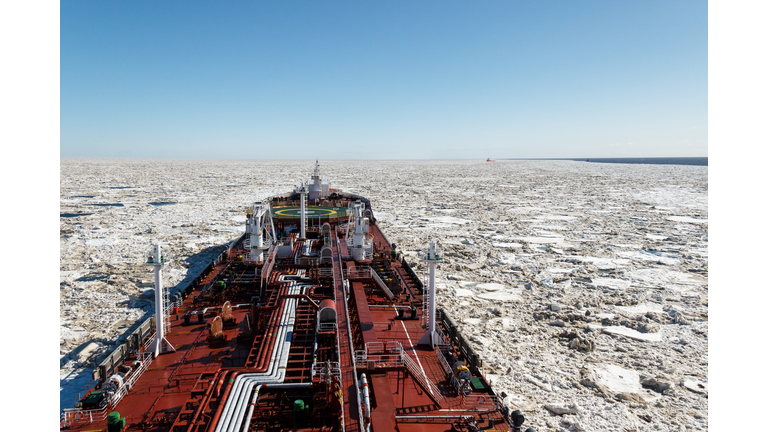 Tanker in polar icy waters in fine weather, blue sky