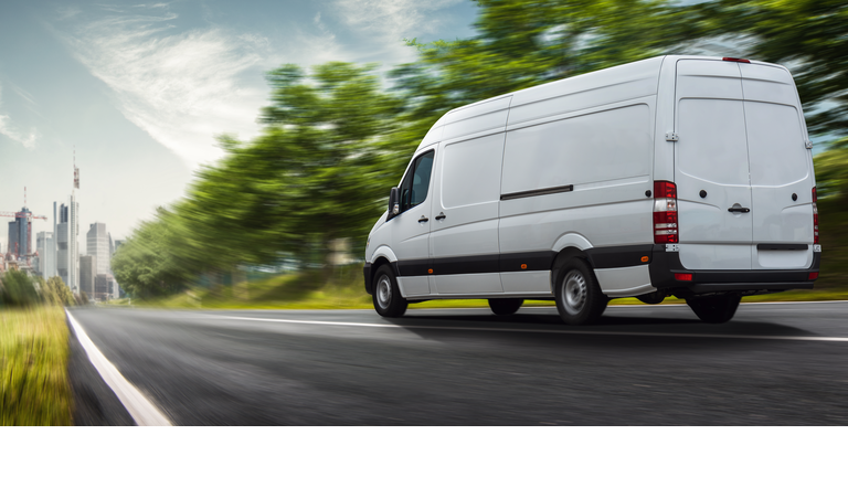 Delivery van delivers in a city