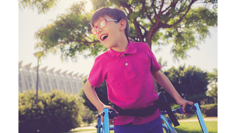 Disability child, walking sticks, cerebral palsy, smiling