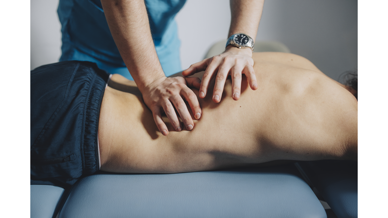 Close up of Physical Therapist Massaging Lower Back