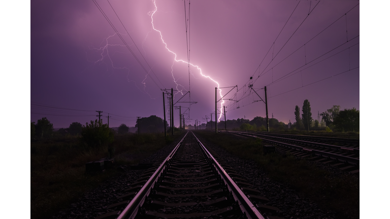 Lightning over the railroad at night